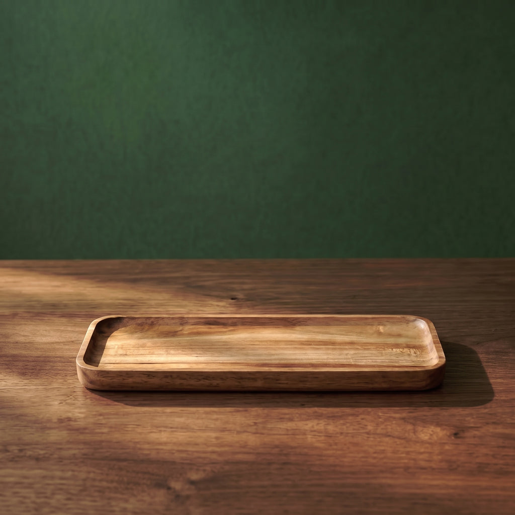 Medium-sized Vance beveled walnut wood tray featuring natural grain patterns and elegant sloped edges, illuminated by warm ambient light.